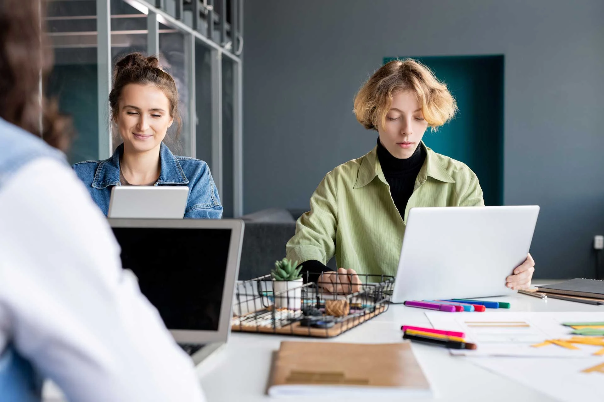 two young creative female programmers working over new oftware in office