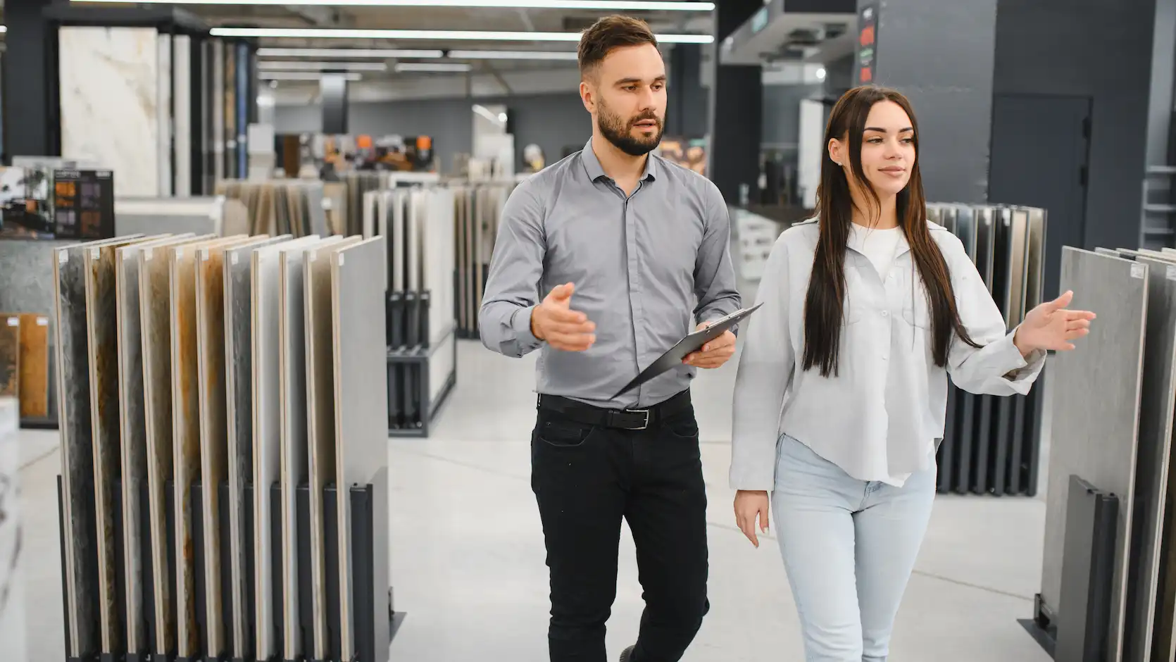salesman assisting female customer choosing