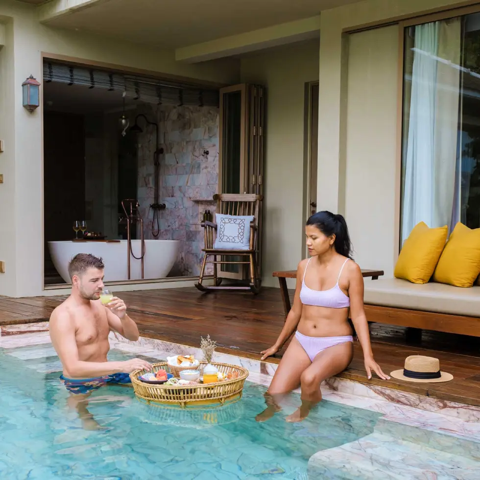 couple men and women on a luxury vacation at a pool
