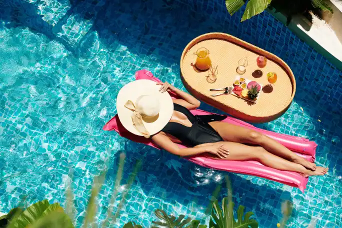 woman sunbathing on floating mattress