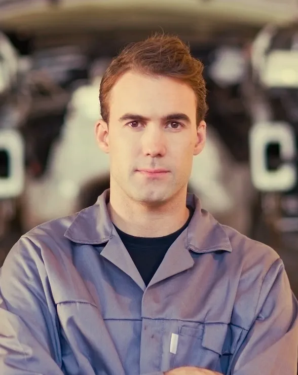 mechanic standing with arms crossed